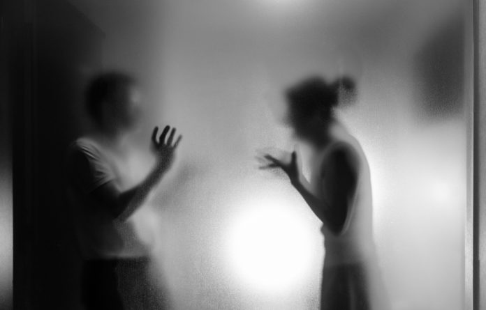 Couple,Arguing,Behind,The,Frosted,Glass