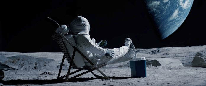 Astronaut,Sits,In,A,Beach,Chair,On,A,Moon,Surface,