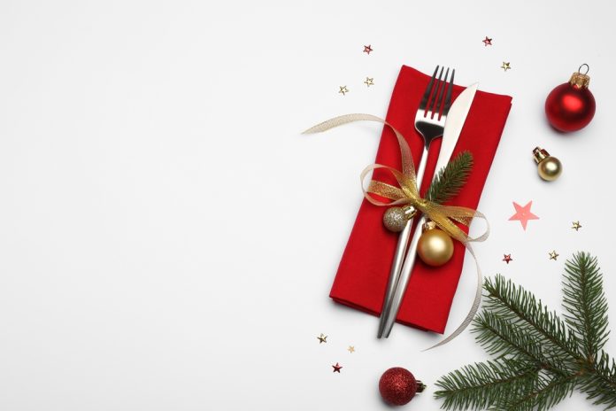 Christmas,Table,Setting.,Cutlery,,Napkin,And,Festive,Decor,On,White