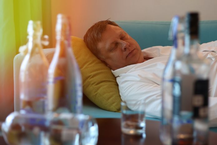 A,Middle,Aged,Man,Rests,On,A,Sofa,Near,A