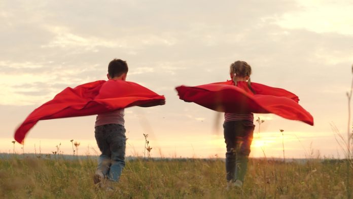 Children,Running,With,Red,Cloaks,On,Backs,Blowing,In,Wind