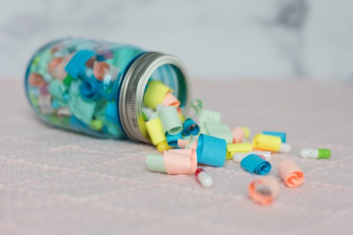 A,Creative,Composition,Of,An,Open,Jar,With,Colorful,Rolled