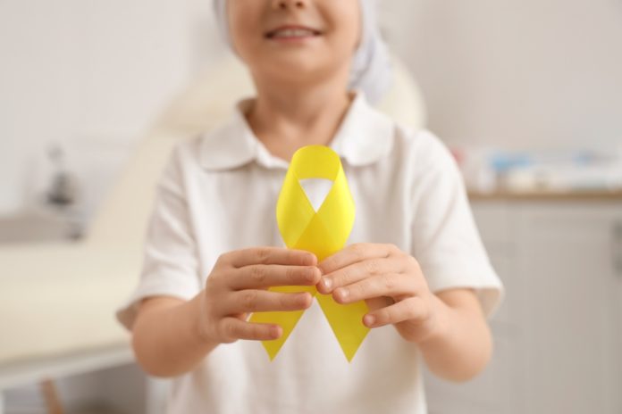 Cute,Little,Girl,After,Chemotherapy,With,Yellow,Ribbon,In,Clinic,