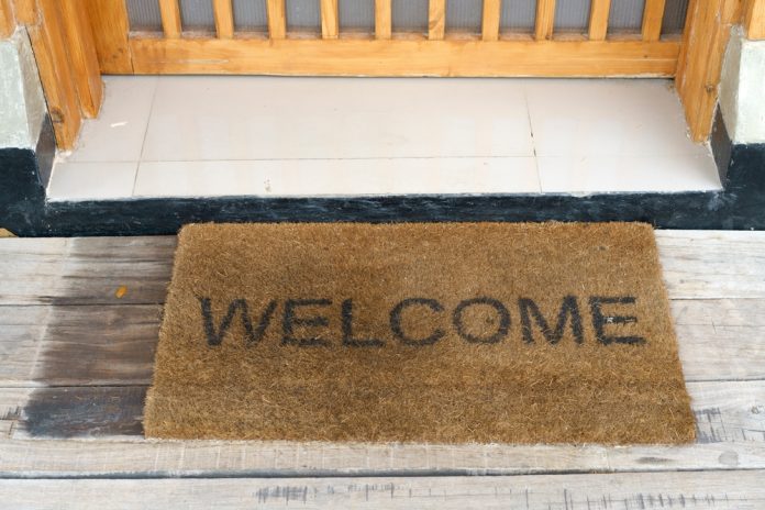Close-up,Of,A,Welcome,Doormat,On,Weathered,Wooden,Planks,At