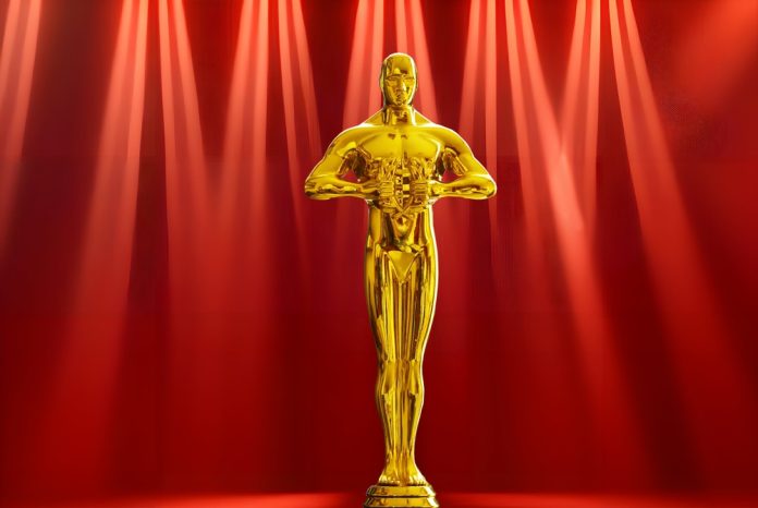 Oscar,Award,Golden,Statuette,On,Red,Background,With,Light,Rays.