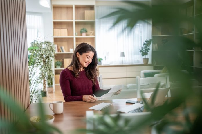 Young,Woman,Smiling,And,Happily,Reading,A,Personal,Letter,At