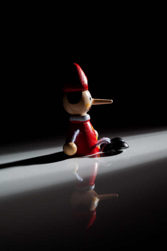 Pinocchio,Doll,On,A,Black,Background,With,Shadow,And,Dramatic