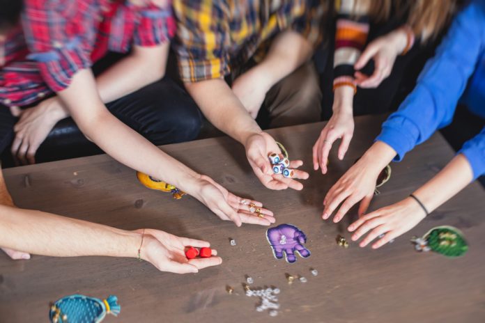 Process,Of,Playing,Board,Game,And,Having,Fun,With,Friends