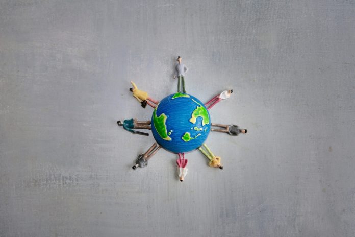 A,Group,Of,Miniature,Toy,People,In,Various,Colors,Stand