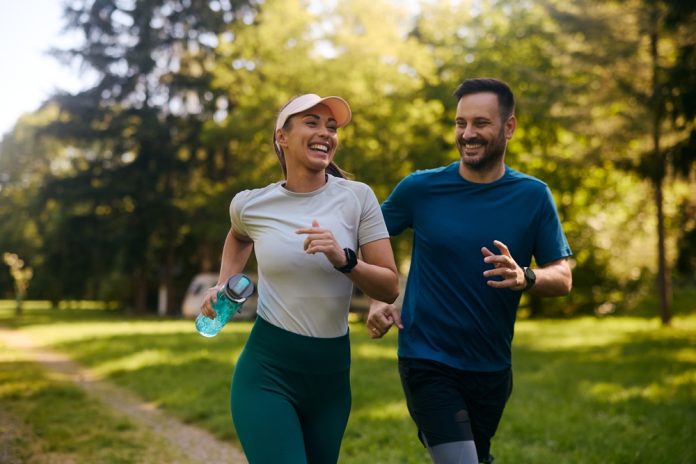 Happy,Athletic,Couple,Having,Fun,While,Running,Together,In,Nature.