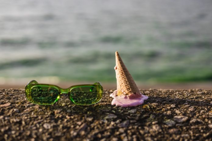 Summer,End.,Green,Sunglasses,Rest,On,The,Rock,Next,To