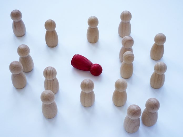 Bystander,Effect,Concept.,Wooden,Figurines,And,In,The,Middle,Lies