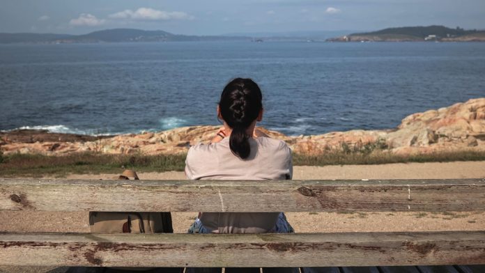 Solitude,By,The,Sea:,A,Woman's,Tranquil,Moment,Of,Reflection