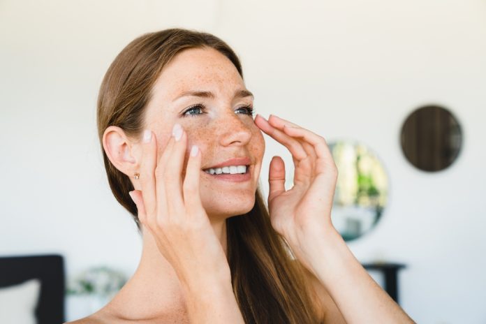Cheerful,Young,Woman,Taking,Care,Of,Her,Facial,Skin,,Applying