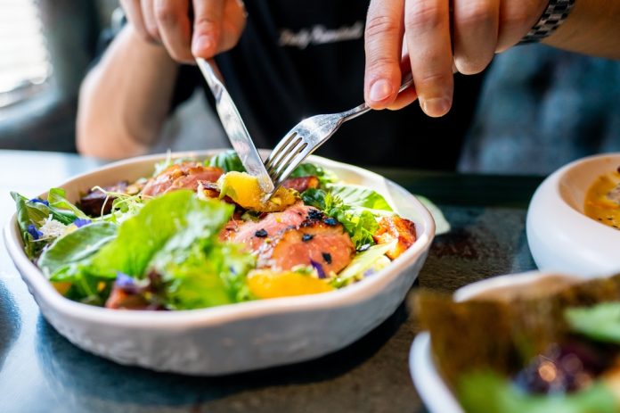 Person,Enjoying,A,Colorful,Salad,With,Fresh,Vegetables,And,Meat,
