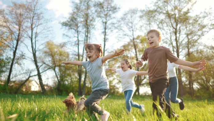 Group,Of,Children,Running,In,The,Park.,Happy,Family,Baby