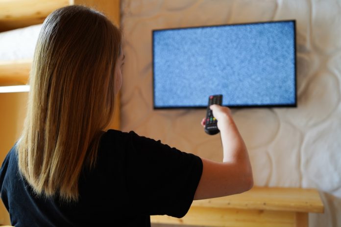 The,Woman,Turns,On,The,Tv,And,There,Is,Digital