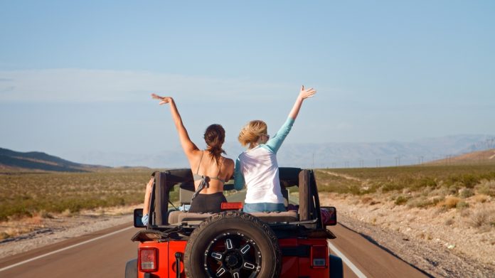 Rear,View,Of,Friends,On,Road,Trip,Driving,Convertible,Car