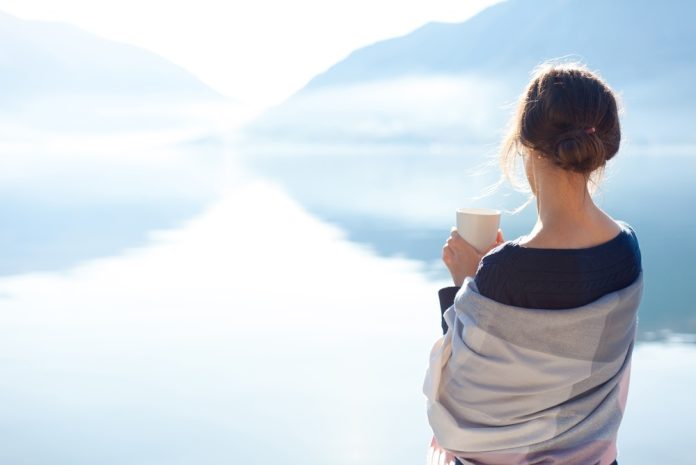 Woman,Relaxing,With,Morning,Coffee,Outdoors,By,Mountain,Lake,,Enjoying