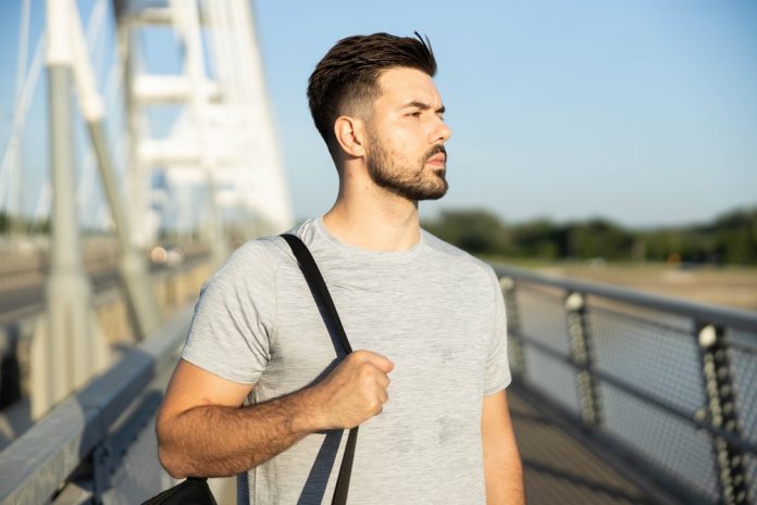 Fit,Man,Carrying,A,Sports,Bag,Looking,Into,The,Distance