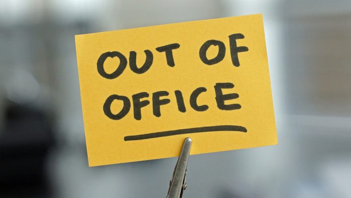 Out,Of,Office,Written,On,A,Card,At,The,Desk