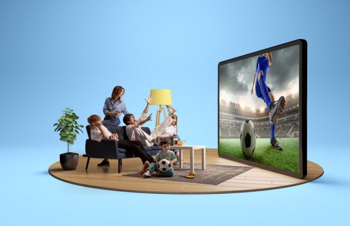 Family,Excitedly,Watching,A,Soccer,Game,On,A,Large,Digital