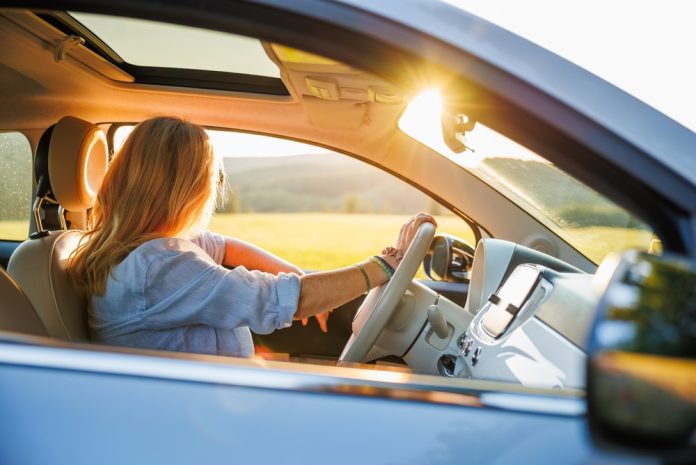 Woman,Driving,Car,During,Summer,Road,Trip,At,Sunset.,Solo