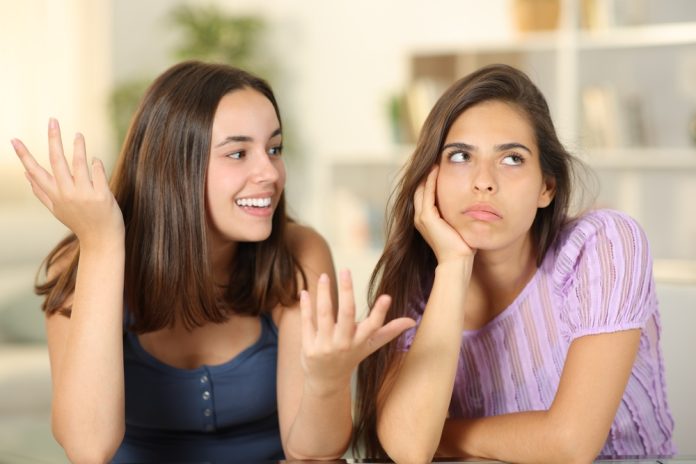 Woman,Ignoring,The,Conversation,Of,Her,Friend,At,Home